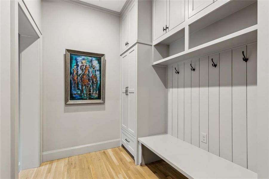 Mudroom featuring baseboards and light wood-style floors