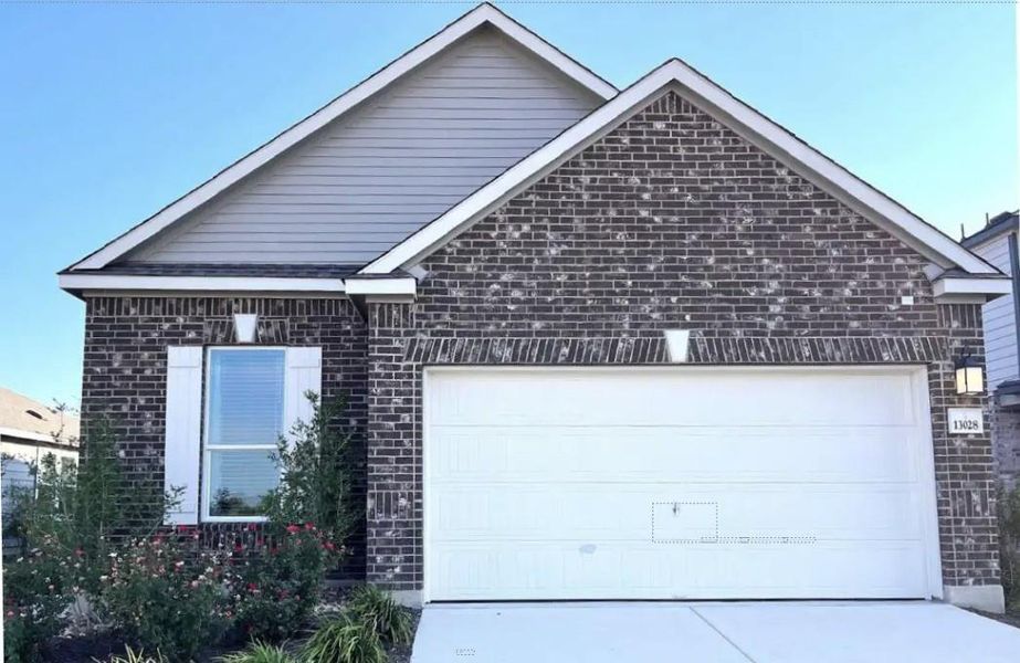 Front exterior of a new home in Hunters Crossing, Sealy, TX, highlighting curb appeal (Image 11).