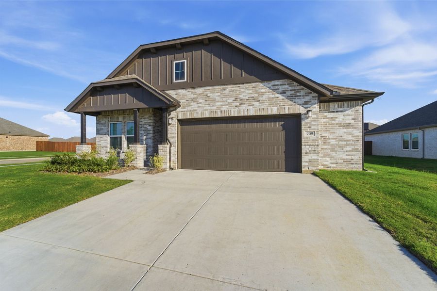 Front exterior of a new home in Saddlebrook Estates, Waxahachie, TX, highlighting curb appeal (Image 27). Front exterior of a new home in Saddlebrook Estates, Waxahachie, TX, highlighting curb appeal (Image 27).