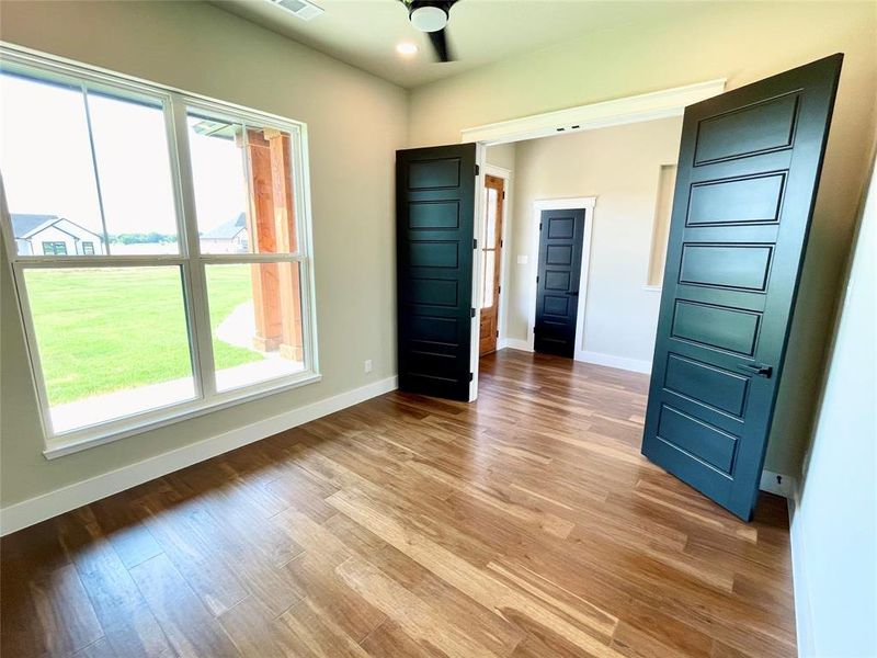 Unfurnished bedroom featuring hardwood / wood-style flooring