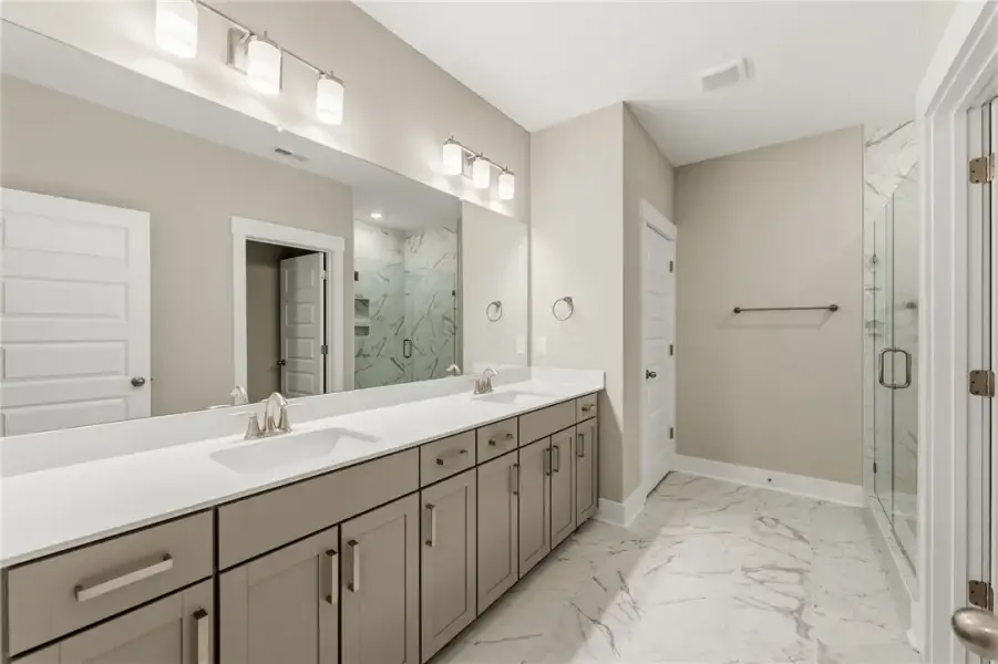 Marble-look tile flooring and a dual-sink vanity c Marble-look tile flooring and a dual-sink vanity c