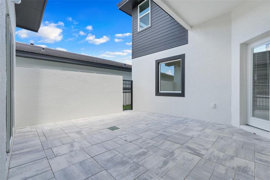 Exterior details and patio area of a home in Hampton Green at Providence, Davenport (Image 28).