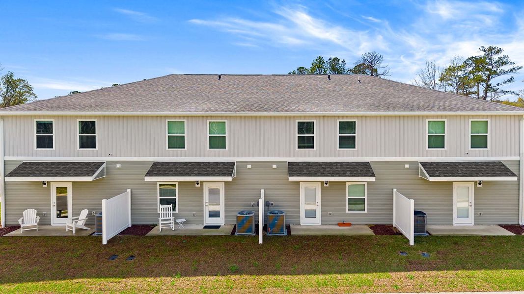 Exterior details and patio area of a home in Genoa Landing Townhomes, Freeport (Image 3).