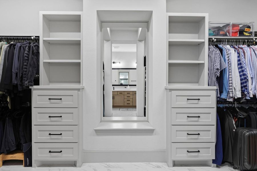 Walk-in Closet with two equal sides and custom cabinets. Walk-in Closet with two equal sides and custom cabinets.