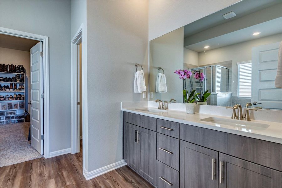 Spa-like primary bathroom with upgraded cabinets.