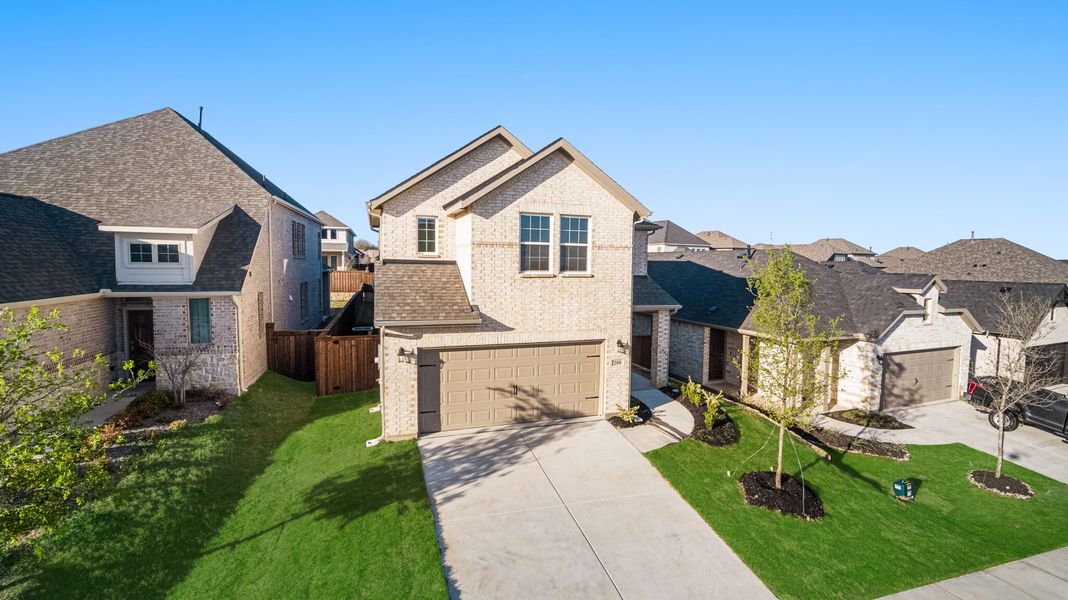 Front exterior of a new home in Reunion, Rhome, TX, highlighting curb appeal (Image 21).