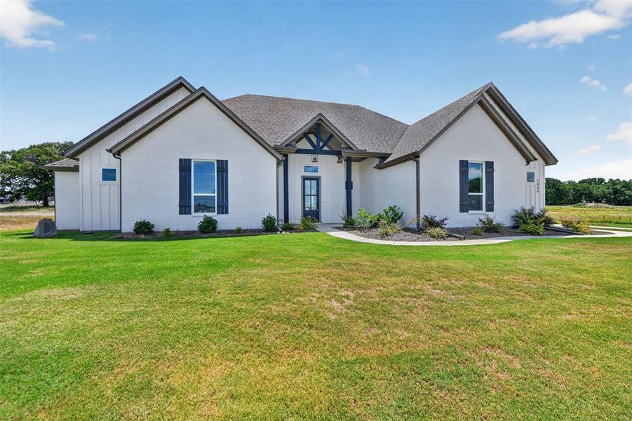 Contemporary ranch-style exterior featuring white brick siding and dark-trimmed gables Contemporary ranch-style exterior featuring white brick siding and dark-trimmed gables