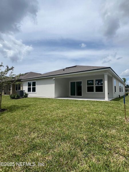 Front exterior of a new home in American Village, Palm Coast, FL, highlighting curb appeal (Image 22).
