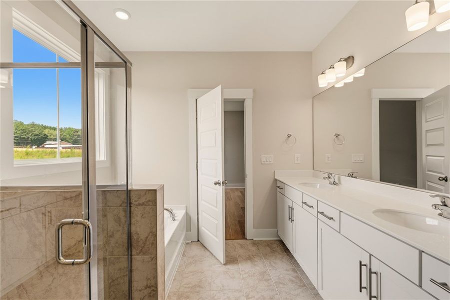 A well-lit bathroom features a spacious walk-in sh