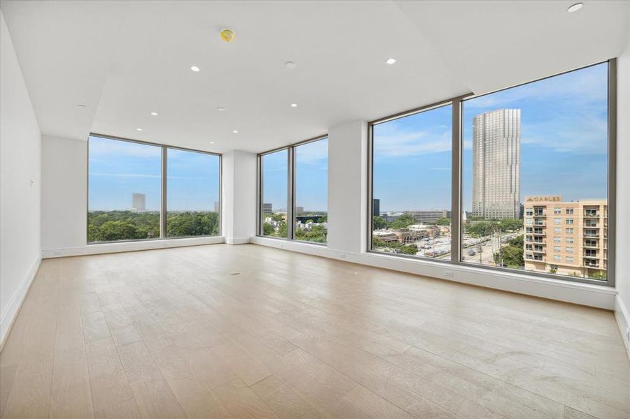 Experience the seamless blend of indoor-outdoor living in the open living/dining space, adorned with floor-to-ceiling windows. Natural light floods the room.