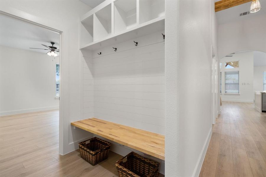 Mudroom with arched walkways, light wood finished floors, and a ceiling fan Mudroom with arched walkways, light wood finished floors, and a ceiling fan