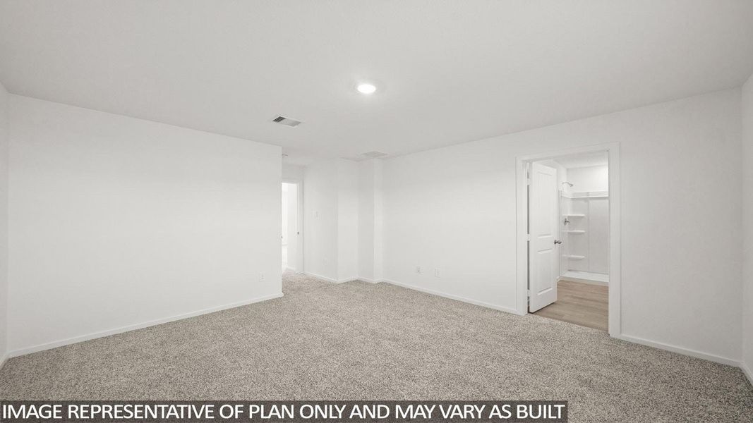 A spacious room offers comfortable carpeting, ready for personalization.