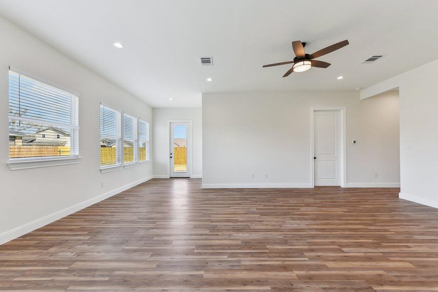 Unfurnished room with recessed lighting, visible vents, baseboards, and wood finished floors Unfurnished room with recessed lighting, visible vents, baseboards, and wood finished floors
