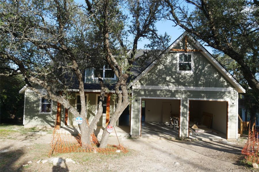 Full view of the home's facade including attached two-car garage and mature shade trees. Full view of the home's facade including attached two-car garage and mature shade trees.