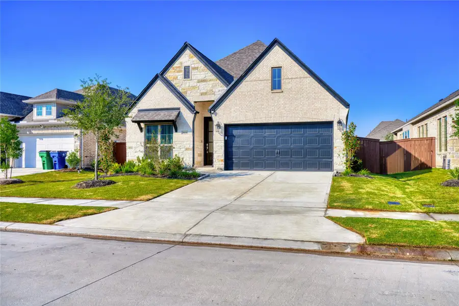 Front exterior of a new home in Meridiana 40'/45', Manvel, TX, highlighting curb appeal (Image 24).