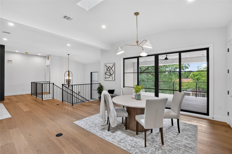 Warm hardwood floors and abundant natural light define this inviting dining area.