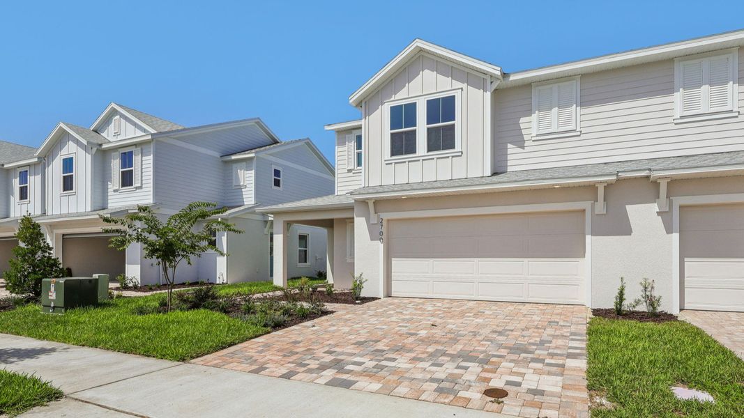 Front exterior of a new home in Cyrene at Harmony, St. Cloud, FL, highlighting curb appeal (Image 2). Front exterior of a new home in Cyrene at Harmony, St. Cloud, FL, highlighting curb appeal (Image 2).
