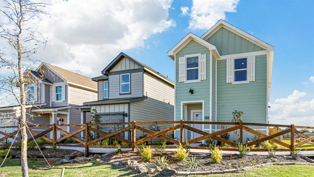 Rear view of property with board and batten siding and a residential view