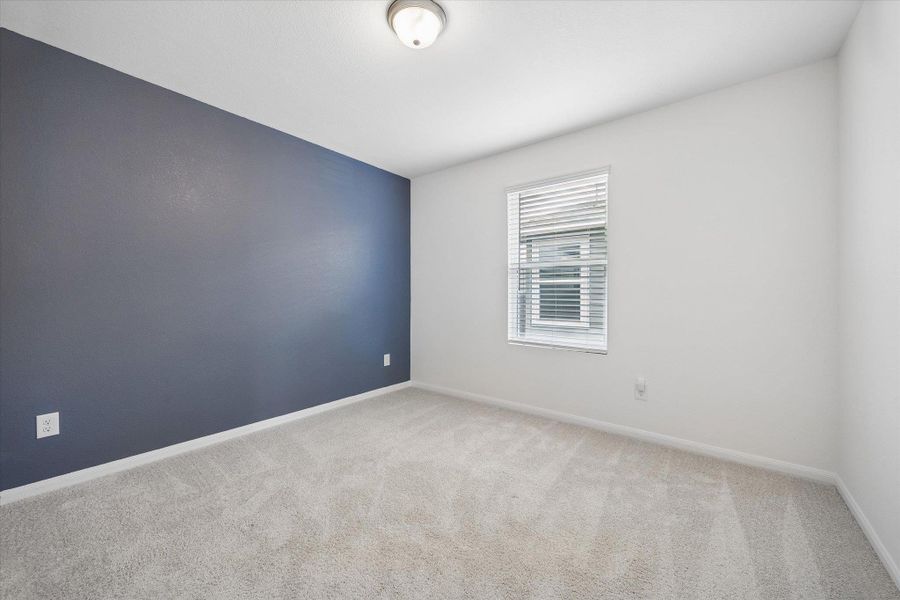 Empty room with light carpet and baseboards