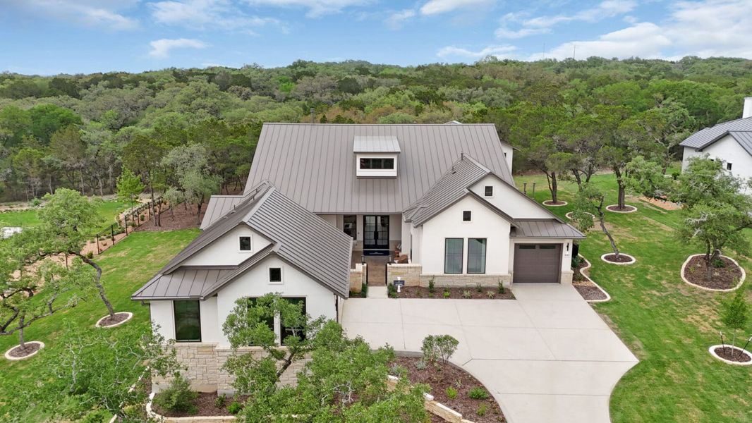 Front exterior of a new home in Enchanted Bluff, Garden Ridge, TX, highlighting curb appeal (Image 23).