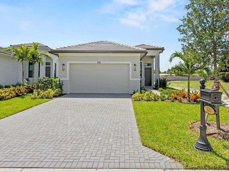 Front exterior of a new home in , Port St. Lucie, FL, highlighting curb appeal (Image 1).
