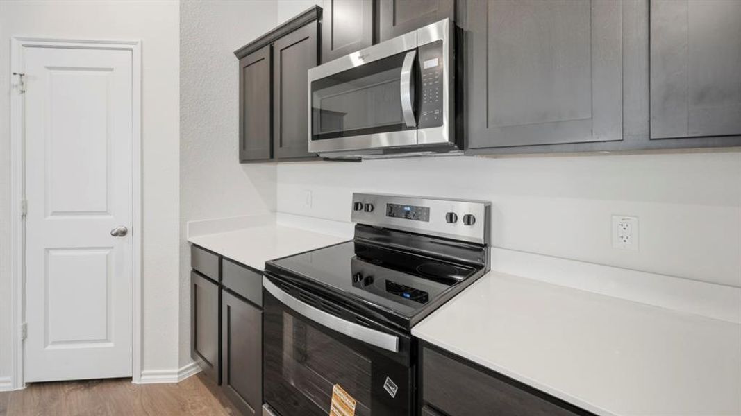 Kitchen featuring appliances with stainless steel finishes and light wood-type flooring