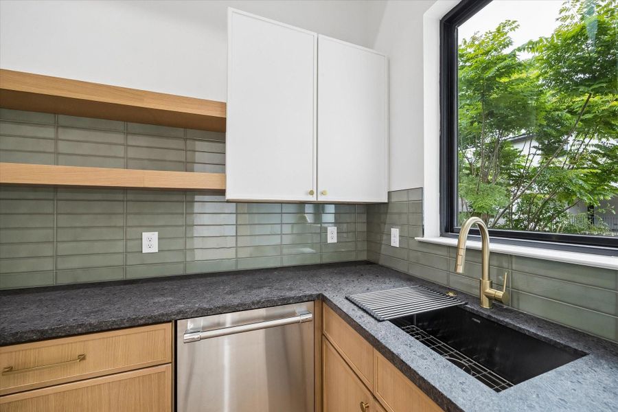 Another deep under-mount sink takes care of the washing up chores and is bestowed good light and a nice view from the large window above.