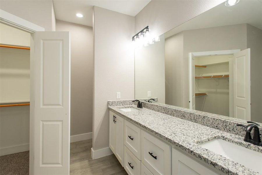 with double vanity and walk in closet