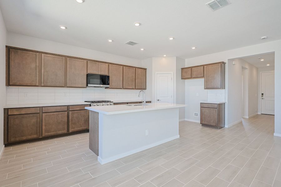 A kitchen with wooden cabinets. A kitchen with wooden cabinets.