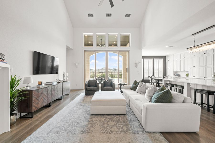 The space feels bright and open as the inside blends uniquely with the outside with the large windows and glass sliding doors bringing in the natural light. The high ceiling adds to the airy feel and the open layout between the living room and kitchen makes the area practical for everyday use and easy for gatherings.