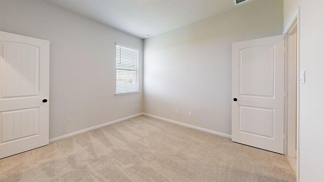 Unfurnished room with light carpet and baseboards Unfurnished room with light carpet and baseboards
