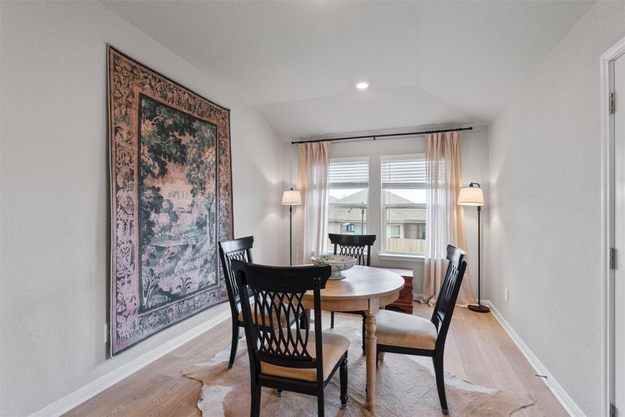 Room featuring wood-finish flooring and neutral wall tones Room featuring wood-finish flooring and neutral wall tones