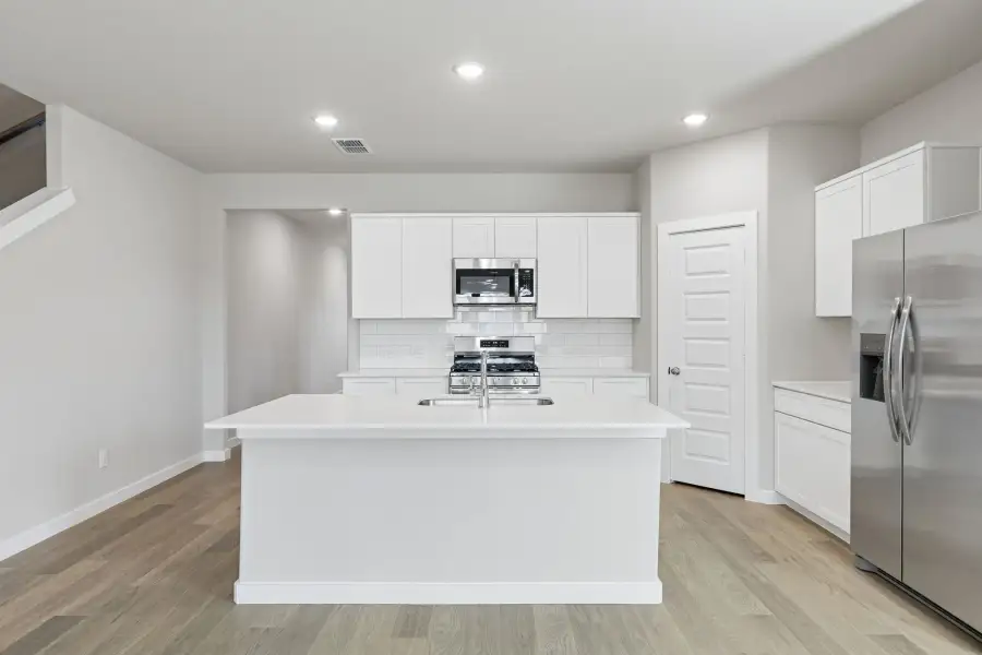 Kitchen in the Holden home plan by Trophy Signature Homes – REPRESENTATIVE PHOTO