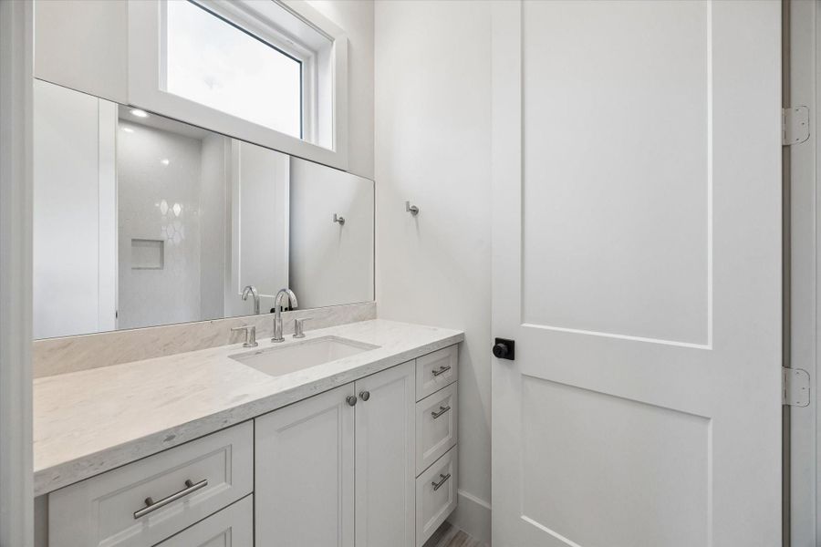 A second sink area in the Jack-and-Jill bath adds convenience and separation, making the shared layout work easily for bedrooms 2 and 3. A second sink area in the Jack-and-Jill bath adds convenience and separation, making the shared layout work easily for bedrooms 2 and 3.