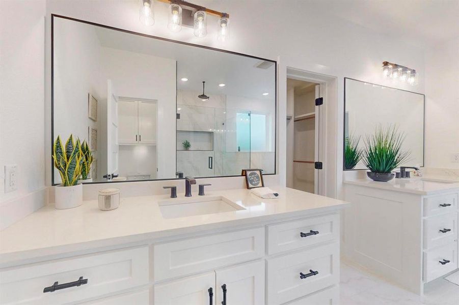 Full bath featuring a stall shower, vanity, and a walk in closet Full bath featuring a stall shower, vanity, and a walk in closet