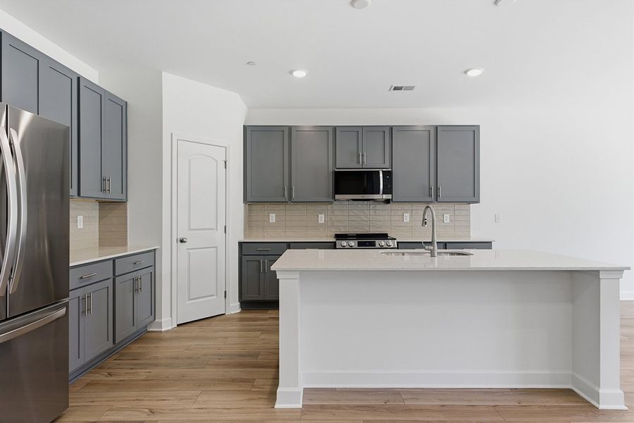 A kitchen with black cabinets. A kitchen with black cabinets.