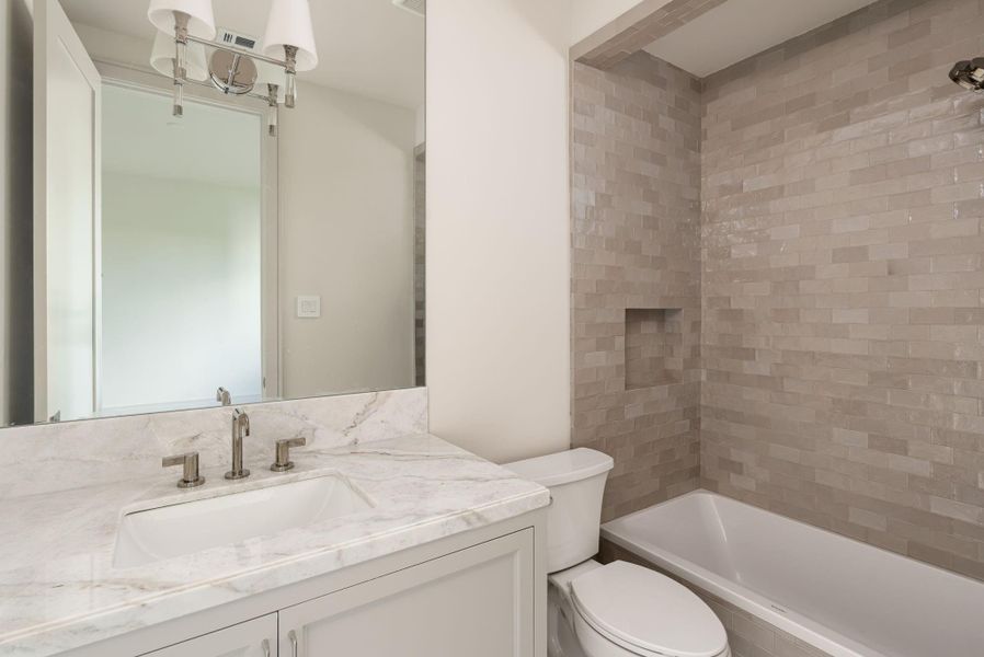 The second-floor secondary bedroom, like all the secondary bedrooms, features a large walk in closet as well as the en-suite bathroom.