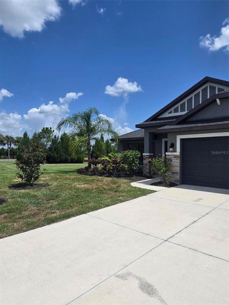 Front exterior of a new home in Aviary at Rutland Ranch, Parrish, FL, highlighting curb appeal (Image 2). Front exterior of a new home in Aviary at Rutland Ranch, Parrish, FL, highlighting curb appeal (Image 2).