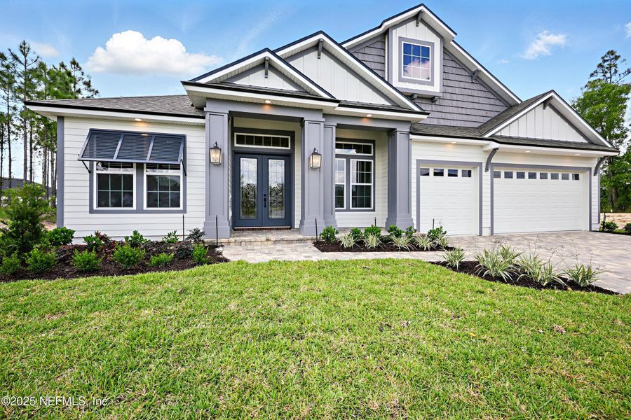 Front exterior of a new home in Courtney Oaks in SilverLeaf, St. Augustine, FL, highlighting curb appeal (Image 22). Front exterior of a new home in Courtney Oaks in SilverLeaf, St. Augustine, FL, highlighting curb appeal (Image 22).