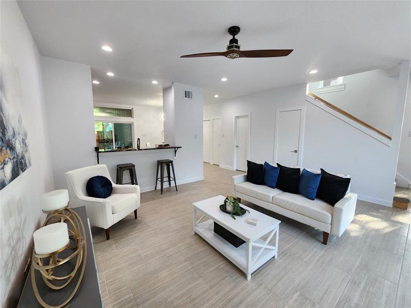 Living room with ceiling fan and sink