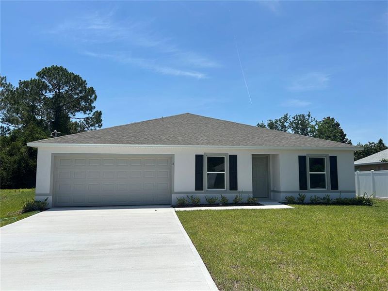 Front exterior of a new home in Palm Coast: Value Collection, Palm Coast, FL, highlighting curb appeal (Image 2).
