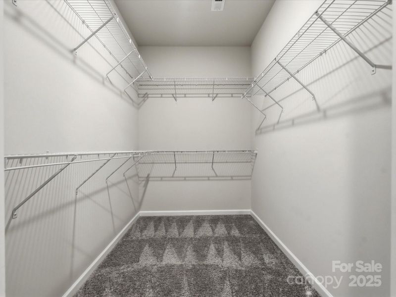 The larger walk-in primary closet-HUGE!