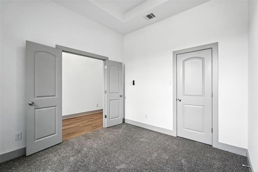 Unfurnished bedroom featuring carpet flooring and baseboards Unfurnished bedroom featuring carpet flooring and baseboards