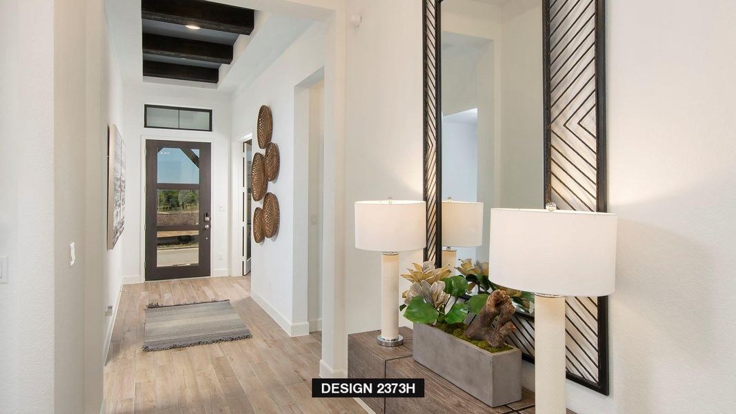 Hall featuring light wood finished floors and beam ceiling Hall featuring light wood finished floors and beam ceiling