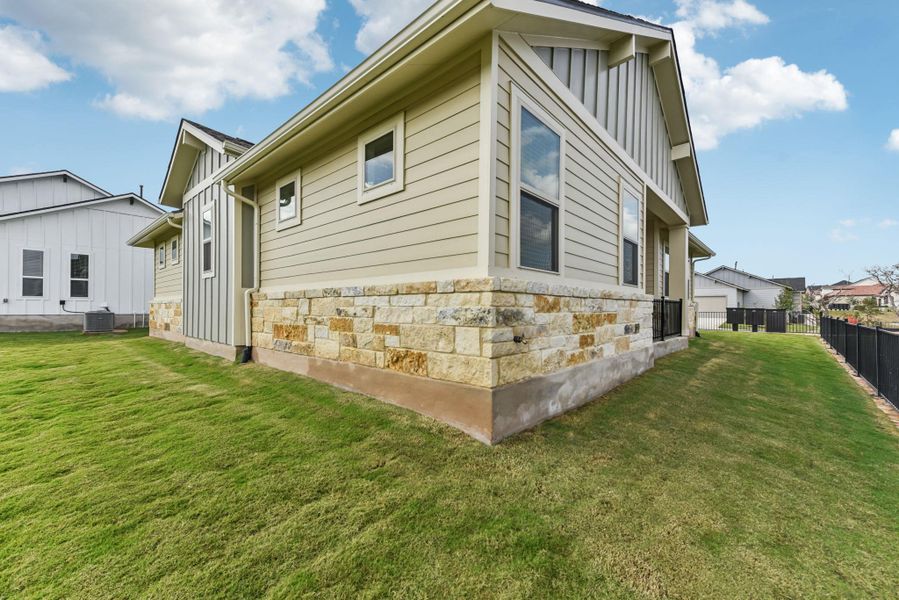View of side of property featuring stone siding and board and batten siding View of side of property featuring stone siding and board and batten siding
