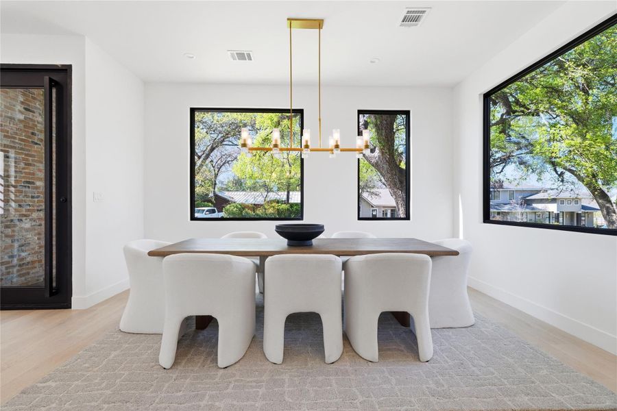 dining area featuring light wood-style flooring and hanging lights