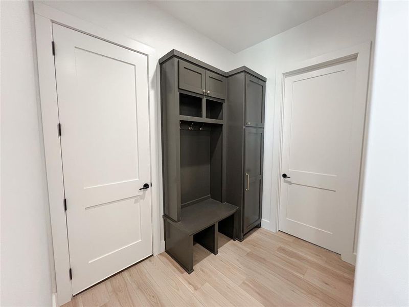 Mudroom with light wood finished floors