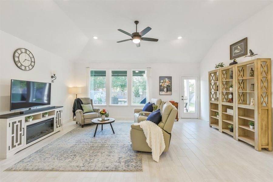 High ceilings and a large ceiling fan complement the family room. A full length glass back door provides beautiful views of the back yard!
