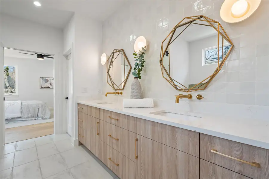 Bathroom with vanity, ceiling fan, and tile walls