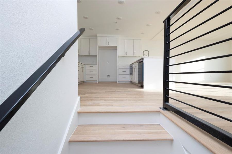 Staircase featuring wood finished floors